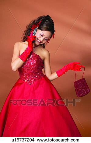 Picture - Colored Background, Happiness, Show Tech, Three-Quarter Length, Evening Gown, Wireless Technology. Fotosearch