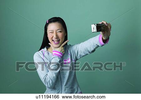 Hand On Chin, One Eye Closed, Chinese Ethnicity, Photography Themes View Large Photo Image Stock Photograph - Hand On Chin, One Eye Closed, Chinese Ethnicity, Photography Themes. Fotosearch
