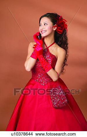 One Person, Colored Background, Chinese Ethnicity, Evening Gown, Looking Sideways, Standing View Large Photo Image Picture - One Person, Colored Background, Chinese Ethnicity, Evening Gown, Looking Sideways, Standing. Fotosearch