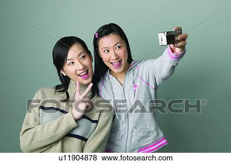 Stock Photo - Victory, Long Hair, Hobbies, Peace Sign, Happiness, Digital Camera. Fotosearch