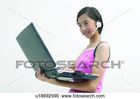 Stock Image - Waist-Up, Headset, Show Tech, Top, Casual Clothing, Asian Ethnicity. Fotosearch