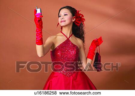 Waist-Up, Posing, Mobile Phone, Eastern, Fashion, Connection, Asian Ethnicity View Large Photo Image Stock Photo - Waist-Up, Posing, Mobile Phone, Eastern, Fashion, Connection, Asian Ethnicity. Fotosearch