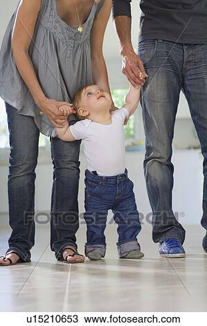 Baby walks looks to parents View Large Photo Image Stock Image - Baby walks looks to parents. Fotosearch