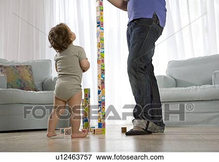 Baby watching father View Large Photo Image Stock Photo - Baby watching father. Fotosearch