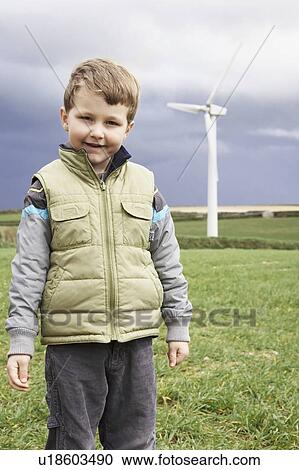 Stock Image - Boy on a wind farm. Fotosearch