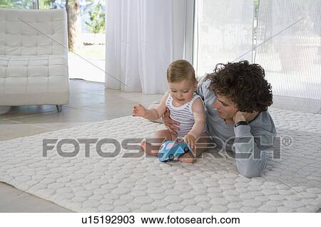 Father and baby play toy car View Large Photo Image Stock Image - Father and baby play toy car. Fotosearch