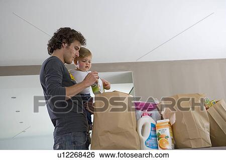 Father and baby with grocery bags View Large Photo Image Stock Photograph - Father and baby with grocery bags. Fotosearch