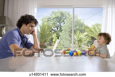 Father and baby working at table View Large Photo Image Stock Image - Father and baby working at table. Fotosearch