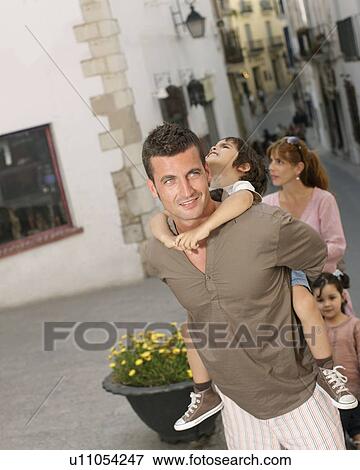 Father carrying son with family View Large Photo Image Stock Photo - Father carrying son with family. Fotosearch