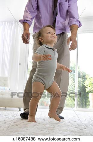 Father watching baby walking View Large Photo Image Stock Photo - Father watching baby walking. Fotosearch