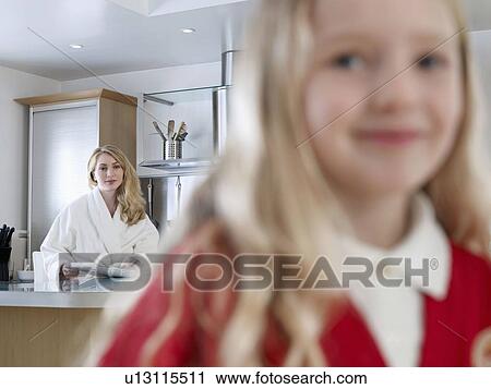 Stock Image - Girl leaving for school in morning. Fotosearch