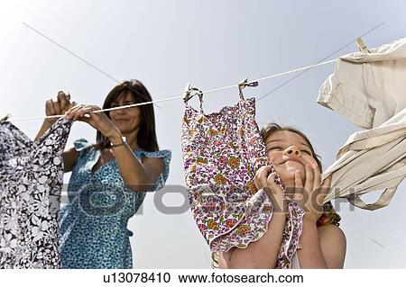 Girl rubbing clothes on face View Large Photo Image Stock Image - Girl rubbing clothes on face. Fotosearch