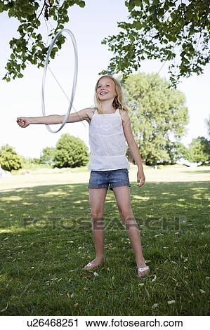 Stock Image - Girl with hula-hoop. Fotosearch