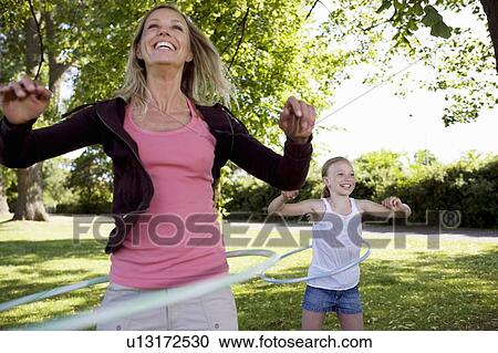 Mother and daughter with hula-hoop View Large Photo Image Stock Image - Mother and daughter with hula-hoop. Fotosearch