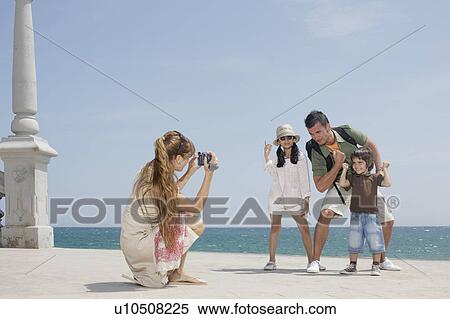 Mother taking video of family by sea View Large Photo Image Stock Photography - Mother taking video of family by sea. Fotosearch