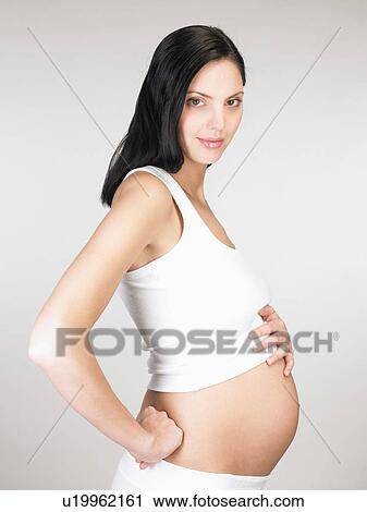 Pregnant woman touching her stomach View Large Photo Image Stock Image - Pregnant woman touching her stomach. Fotosearch