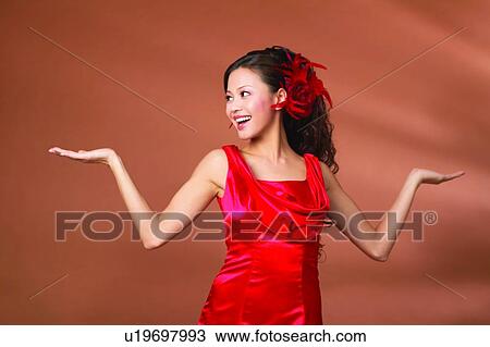 Stock Image - Asian Ethnicity, Close-Up, Casual Clothing, Black Hair, Arms Raised. Fotosearch