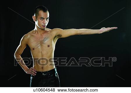 Stock Photo - Bare Chest, Black Hair, Black Background, Asian Ethnicity. Fotosearch