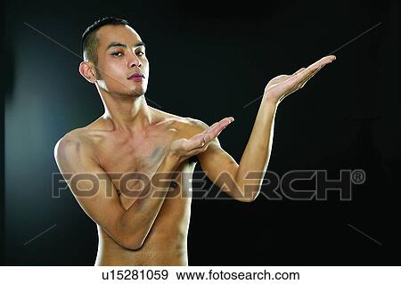 Stock Photo - Close-Up, Attitude, Black Hair, Black Background, Bare Chest, Asian Ethnicity. Fotosearch