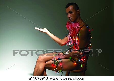 Stock Image - Electric Light, Indoor, Communication, Lifestyles, Gesturing, Three-Quarter Length. Fotosearch