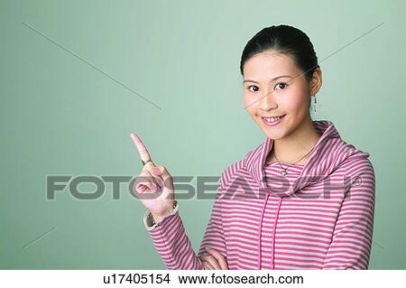 Picture - Happiness, Lifestyles, Portrait, Asian Ethnicity, Gesturing, Pointing, Black Hair. Fotosearch