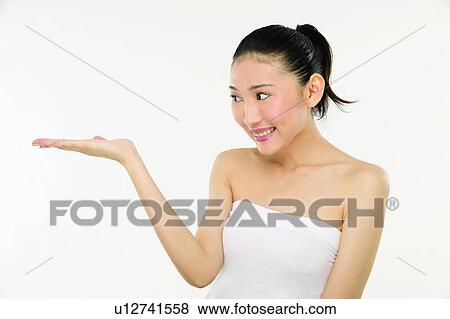 Stock Photo - One Person, Toothy Smile, Tube Top, Posing, Young Adult, Indoor, Signals. Fotosearch