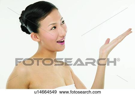 Stock Photo - One Young Woman Only, Posing, Casual Clothing, Communication, Gesturing, Happiness. Fotosearch