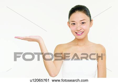 Stock Image - Tube Top, Looking At Camera, Gesturing, Young Adult, Hand Raised, Indoor. Fotosearch