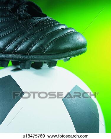 Stock Photo - sporting good, close up, soccer ball, soccer shoes. Fotosearch