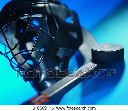 Stock Photography - sporting good, hockey stick, close up, hockey helmet, puck. Fotosearch