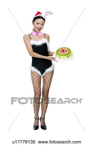 Stock Photography - Bow, Black Hair, Holding, Imitation, Rabbit Ears, Indoor. Fotosearch