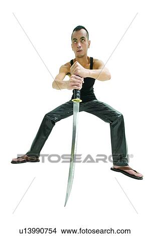 Picture - Chinese Ethnicity, White Background, Standing, Anticipation, Holding, Style, Legs Apart. Fotosearch