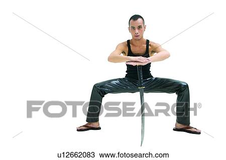 Stock Image - Sword, Indoor, Looking At Camera, Preparation, Martial Arts. Fotosearch