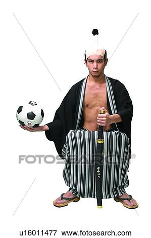 Stock Photo - Sword, Looking At Camera, Bizarre, Serious, Traditional Culture, Soccer Ball. Fotosearch