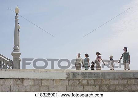 Family taking stroll shot from low angle View Large Photo Image Stock Image - Family taking stroll shot from low angle. Fotosearch