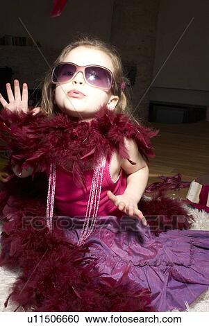 Stock Image - Girl (2-4) dressed for party, acting like a diva.. Fotosearch