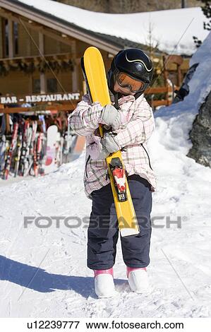 Girl holding skis View Large Photo Image Stock Photo - Girl holding skis. Fotosearch