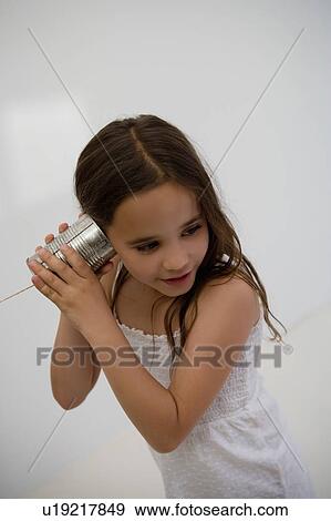 Girl using a tin can as a phone. View Large Photo Image Stock Photo - Girl using a tin can as a phone.. Fotosearch