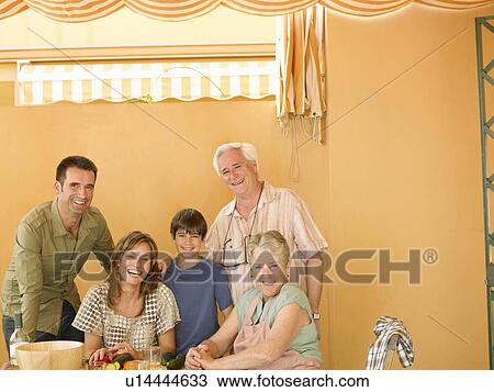 Multi-generational family preparing food at home, smiling, portrait View Large Photo Image Stock Image - Multi-generational family preparing food at home, smiling, portrait. Fotosearch