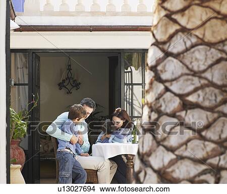 Parents sitting in garden with two sons (5-7) View Large Photo Image Picture - Parents sitting in garden with two sons (5-7). Fotosearch