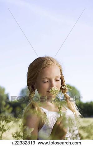 Stock Photo - Portrait of young girl with flowers. Fotosearch