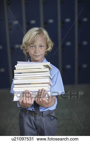 School boy holding stack of books View Large Photo Image Stock Image - School boy holding stack of books. Fotosearch