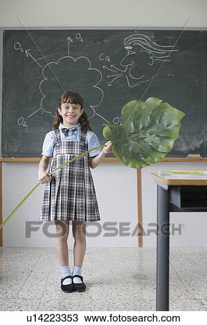 Stock Image - School girl giving science presentation. Fotosearch