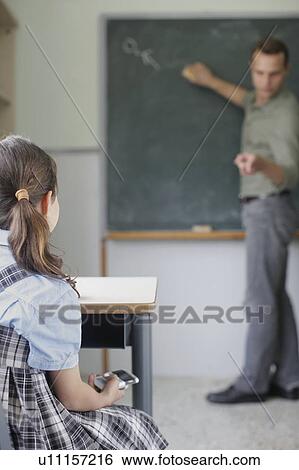 School girl texting in class View Large Photo Image Stock Photograph - School girl texting in class. Fotosearch