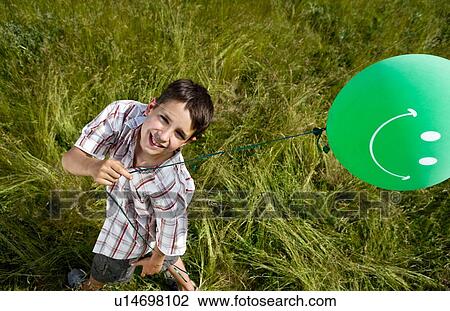 Boy holding balloon, elevated View Large Photo Image Stock Image - Boy holding balloon, elevated. Fotosearch