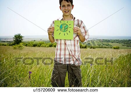 Stock Photo - Boy holding picture of earth. Fotosearch