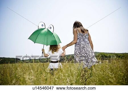 Stock Photo - Mother and daughter walking. Fotosearch