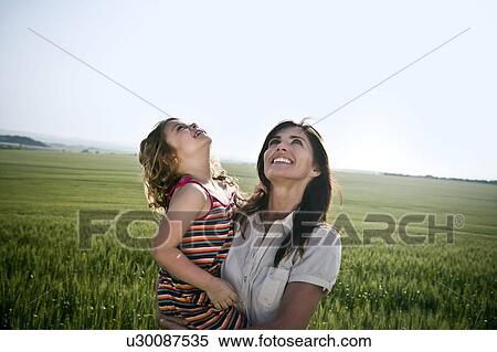 Stock Photography - Woman and child looking at sky. Fotosearch