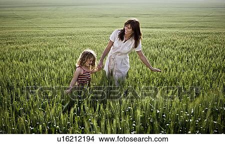 Picture - Woman and child walking in wheat-field. Fotosearch