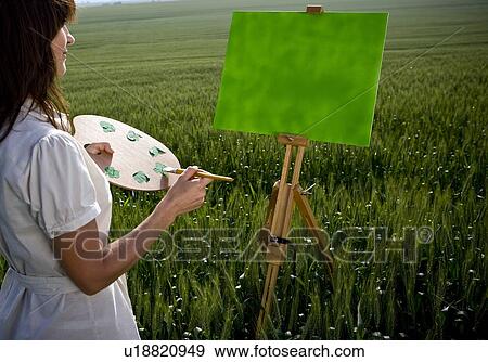 Stock Photo - Woman painting in wheat-field. Fotosearch